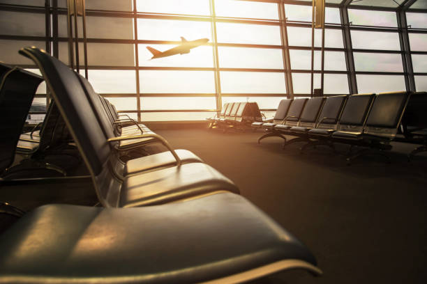 istock Airport Terminal with empty chair and bursting light, Airplane Boarding outside as background 811904082