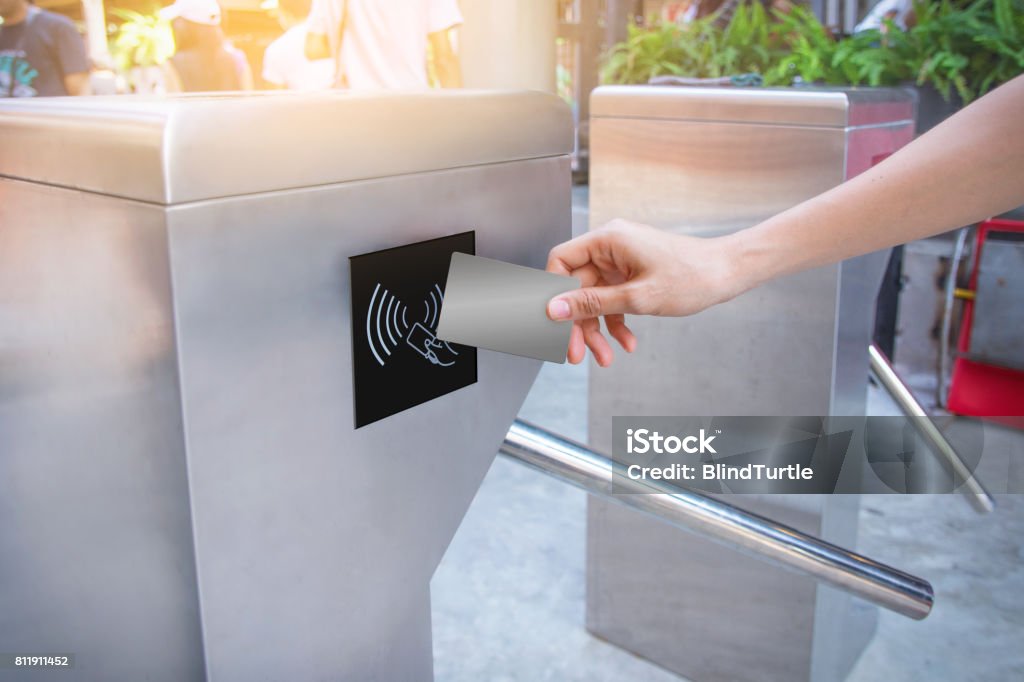 entrance gate card Woman use card for touch of entrance gate card access Security system. Control Stock Photo