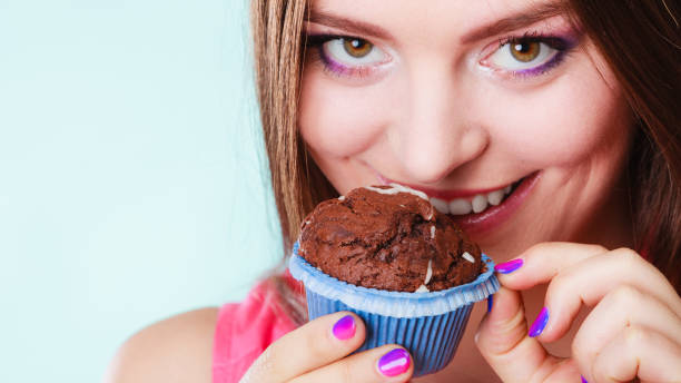 istock Smiling woman holds chocolate cake in hand 811911942
