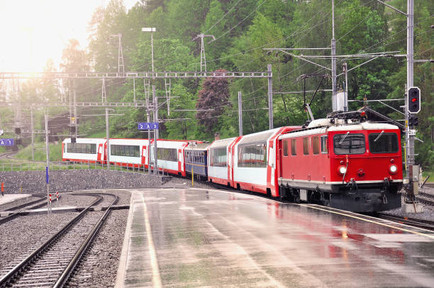 Train from Davos arrives to Filisur station at rainy day time. Switzerland.