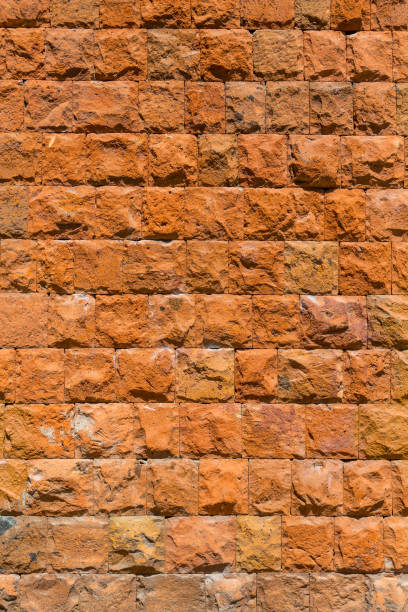 istock A wall of red stone. Textured background 811914296