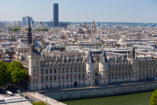 Paris, France - July 07 2017: View of the Palais de justice (including the Conciergerie and the Sainte Chapelle which are part of the complex), the Pont au Change and the Seine River from the Tour Saint-Jacques, with in the behind, the Tour Montparnasse, the Église Saint-Sulpice.