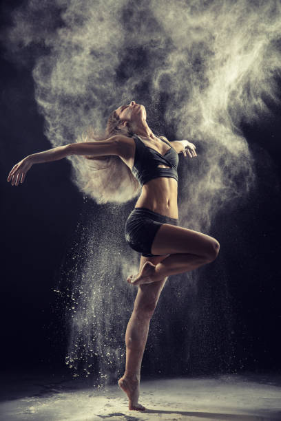 istock Amazing ballet dancer dancing in powder snow 811936560