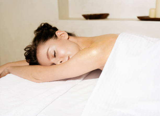 istock Woman laying on massage table 811944190