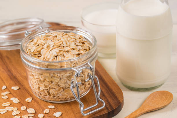 istock Oat flakes in glass jar and milk bottle 811947774