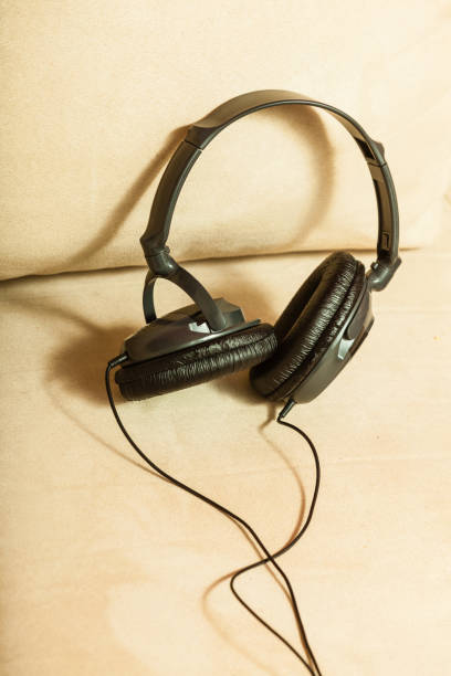 istock Big headphones lying on white sofa 811950288