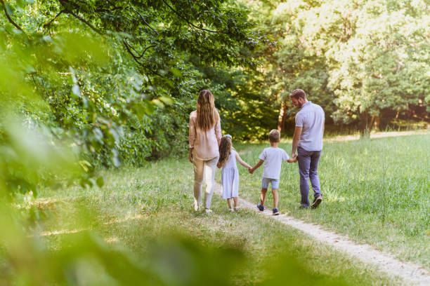 family enjoying beutiful summer day in nature - child rear view running nature imagens e fotografias de stock