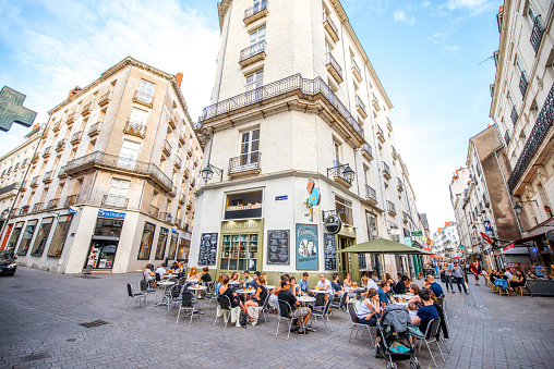NANTES, FRANCE - May 27, 2017: Street view with cafes and restaurant full of people in the old town of Nantes city in France