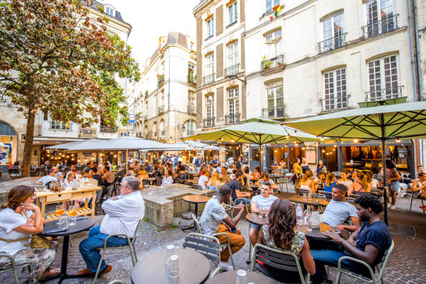 Nantes city in France NANTES, FRANCE - May 27, 2017: Street view with cafes and restaurant full of people in the old town of Nantes city in France loire atlantique photos stock pictures, royalty-free photos & images