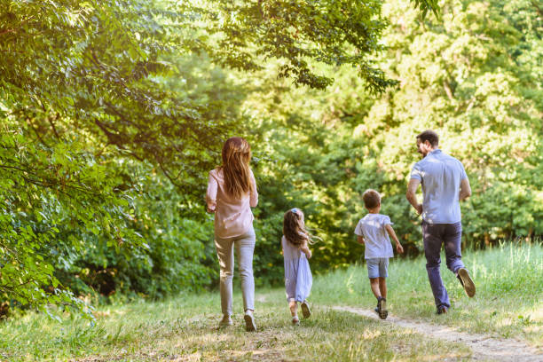 istock Young playful family having fun running in nature 811961596