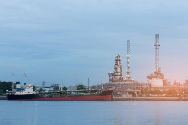istock Tank ship on the river over oil refinery 811963786