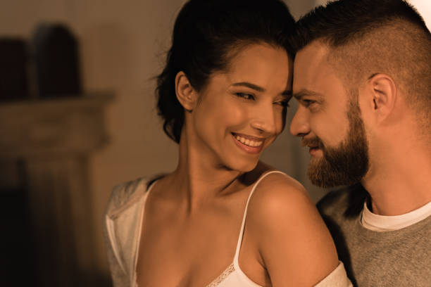 istock young affectionate couple smiling and able to kiss at home 811964792