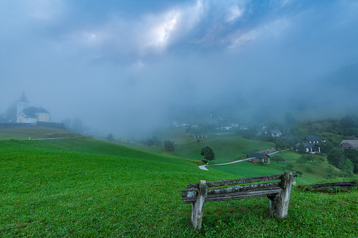 Empty bench overlooking Sorica village in Slovenia.