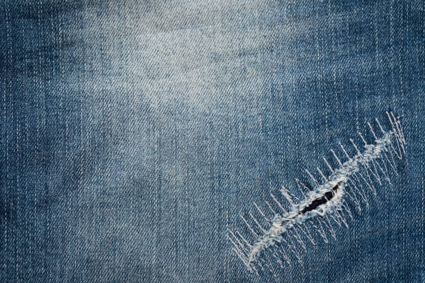 istock Texture of vintage blue jeans background, ripped jeans. 811970486