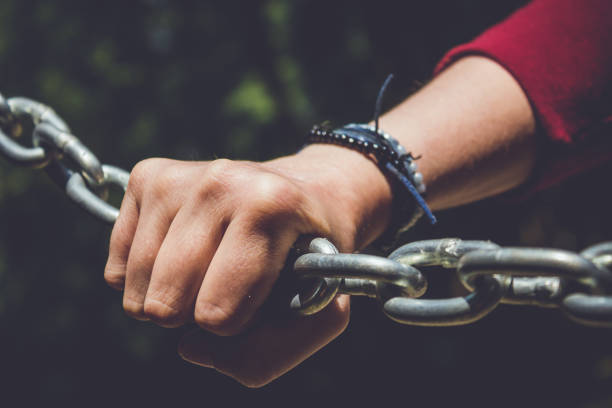 istock Young hand on a stainless steel chain 811980158