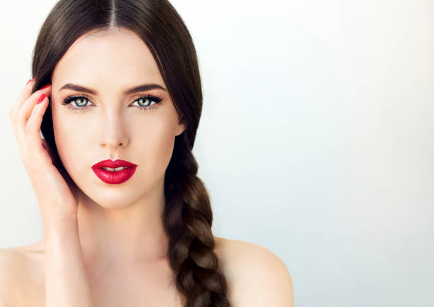 young brunette woman-model with long braided hair and red manicure. - braided braids women long hair imagens e fotografias de stock