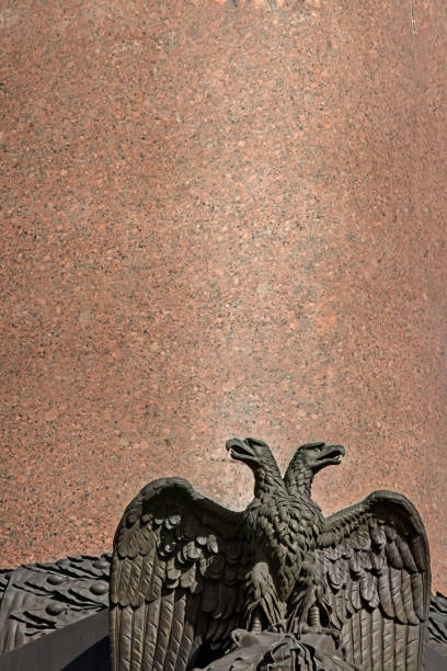 istock Two-headed eagle sculpture on a granite backdrop of the Alexander column on Palace Square in Petersburg 812009754