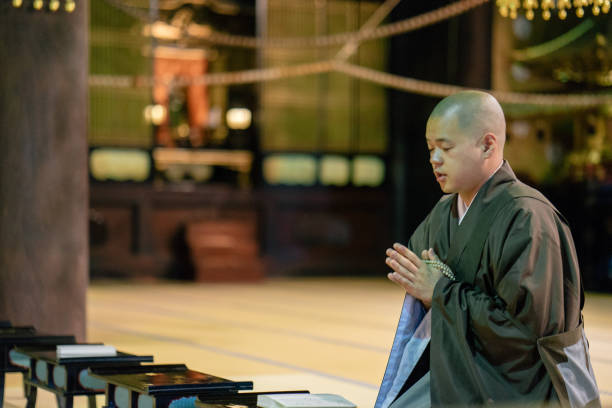 istock Monk praying during morning cerimony inside a buddhist temple 812031824