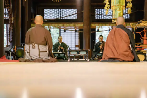 Monks praying during morning cerimony inside a buddhist temple