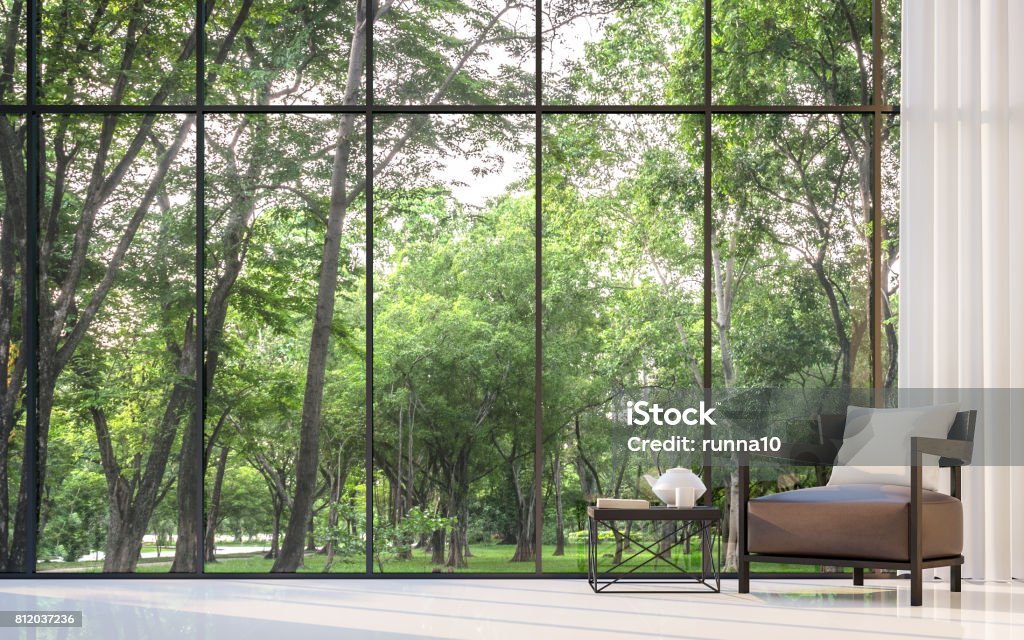 Modern living room with garden view 3d rendering Image Modern living room with garden view 3d rendering Image.There are large window overlooking the surrounding garden and nature Window Stock Photo