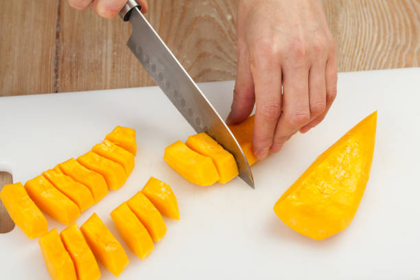 istock Cutting the vegetables with a kitchen knife on the board 812047072