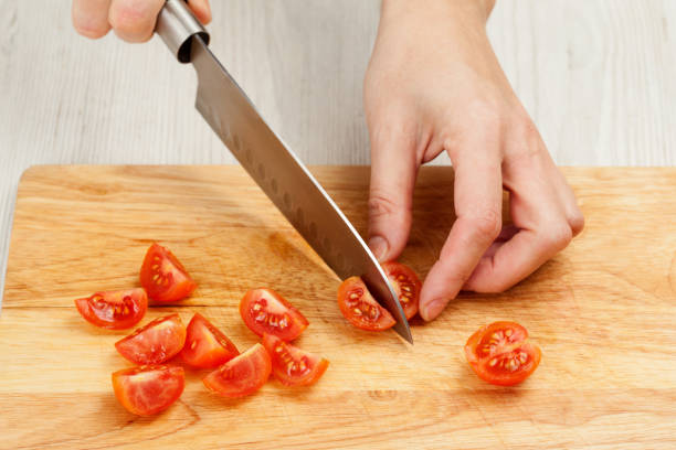 istock Cutting the vegetables with a kitchen knife on the board 812047120