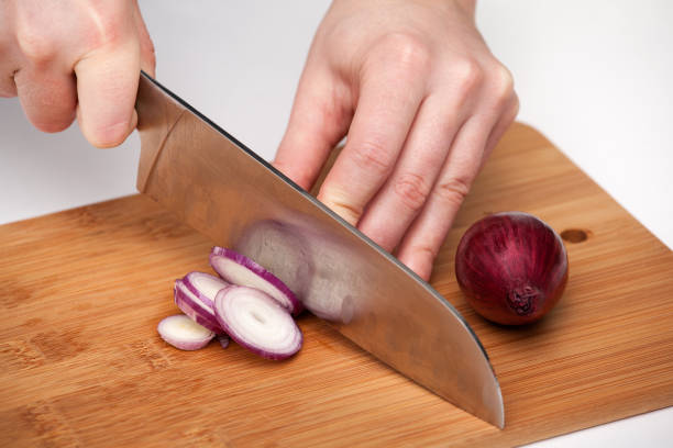 istock Cutting the vegetables with a kitchen knife on the board 812047164
