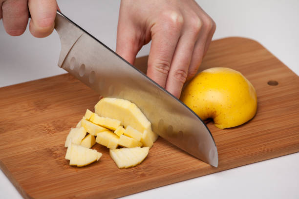 istock Cutting the fruit knife on a chopping board 812047208