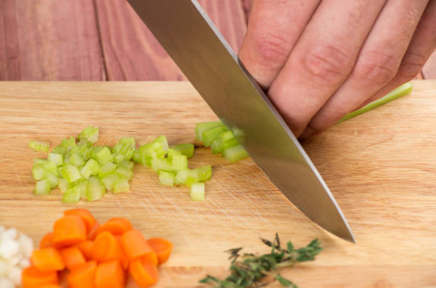istock Cutting the vegetables with a kitchen knife on the board 812047262