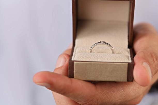 istock Man holding gift box with diamond Engagement ring close up. Love, Wedding, Proposing, Marriage concept. Surprise St. Valentine day present 812049614