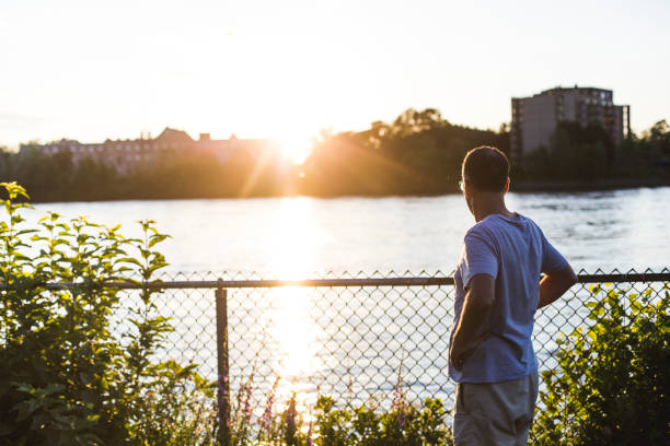 istock A mature man looking at a river at sunset 812052502