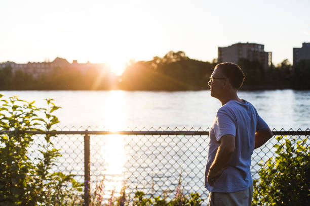 istock A mature man walking by a river at sunset 812052518