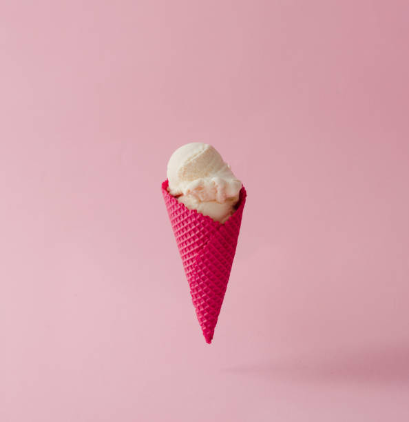 istock Vanilla ice cream in red cone on pink pastel background. Summer creative concept. 812085580