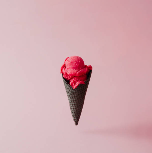istock Strawberry ice cream in black cone on pink pastel background. Summer creative concept. 812085586