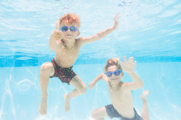 istock Kids Having Fun Underwater In A Pool 812093014
