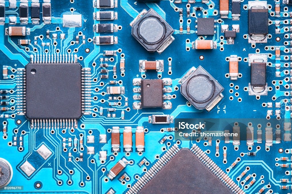 printed circuit board macro top view of a printed circuit board with processors, capacitors and transistors Computer Chip Stock Photo