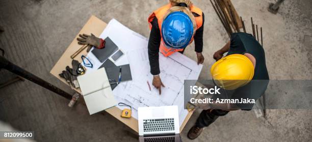 Checking The Blueprints Stock Photo - Download Image Now - Construction Site, Construction Industry, Blueprint