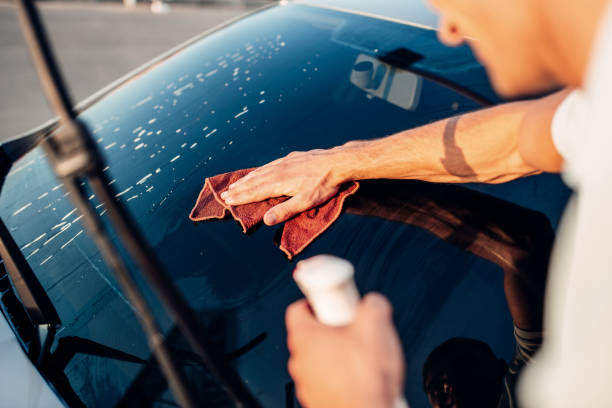 istock Male hand with tool for washing windows, car wash 812099782