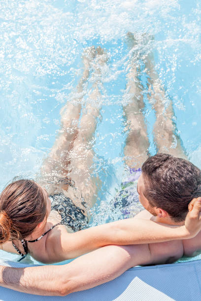 istock Young loving couple relaxes in the hydromassage 812104040