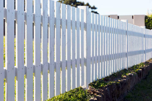 istock White picket fence in sunlight, backgroud with copy space 812130152