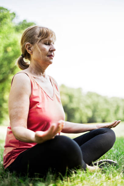 istock Senior woman meditating 812146304