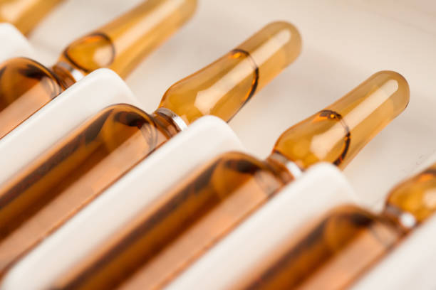 medical ampoules packaging horizontal perspective view of many brown ampoules set in pharmaceutical packaging white container ampoule photos stock pictures, royalty-free photos & images