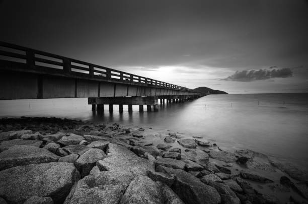 istock A Bridge to an island at sunset with water and rock 812176502