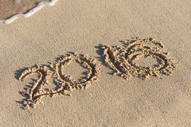 istock Inscription 2016 on sandy beach with wave's foam 812201758