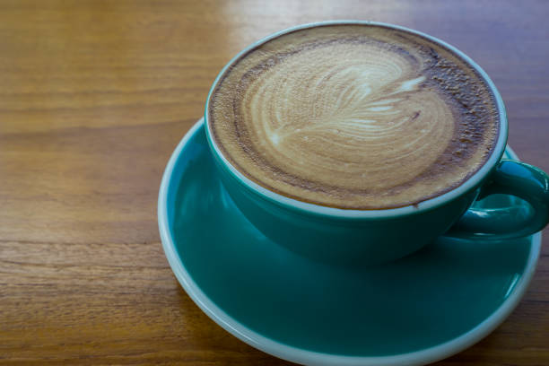 istock Hot coffee in green cup on wooden background 812207240