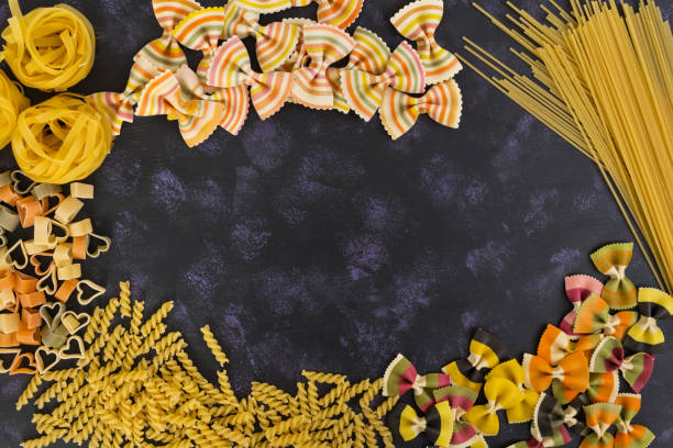 istock Dry pasta background. Different pasta on dark background. Flat lay. Top view. 812215922
