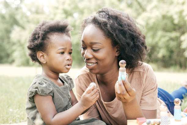 istock Playing outside the house with mom and dolls 812232084