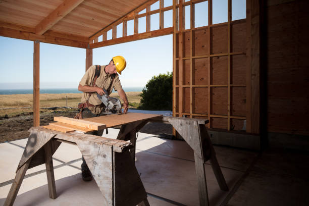 Home Building - Sawing Carpenter building a home at construction site sawhorse stock pictures, royalty-free photos & images