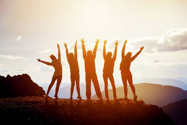 istock Five happy friends with raised arms 812271728