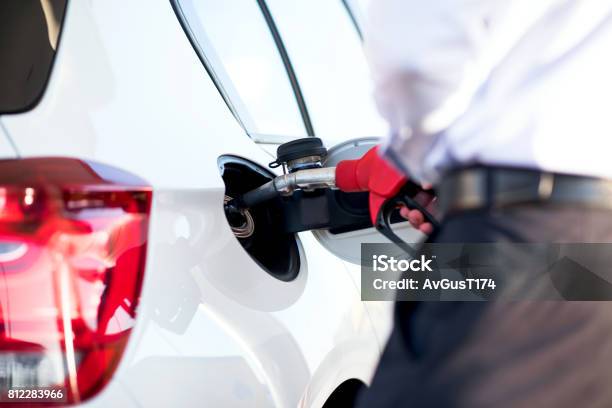 Man Fills A Car With Petrol Stock Photo - Download Image Now - Biofuel, Business Finance and Industry, Car